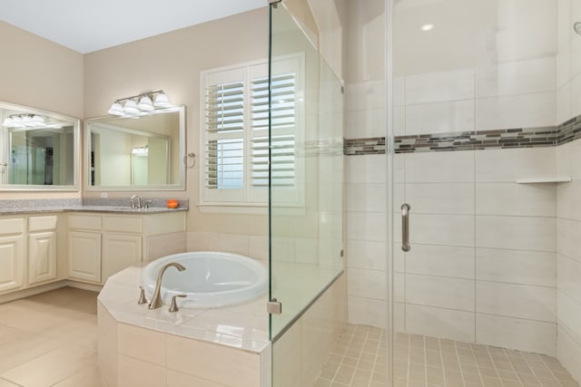 bathroom with vanity, tile patterned flooring, and plus walk in shower