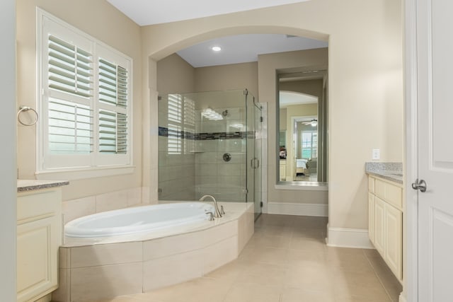 bathroom with tile patterned flooring, vanity, and independent shower and bath