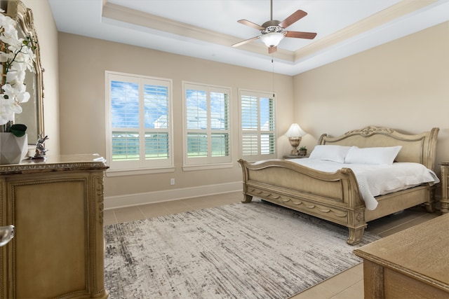 bedroom with a raised ceiling, ceiling fan, ornamental molding, and light tile patterned flooring