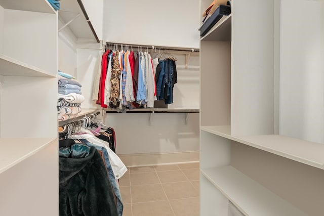 spacious closet with light tile patterned floors