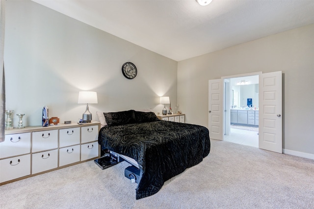 carpeted bedroom featuring connected bathroom