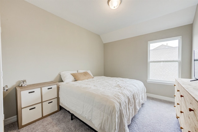 carpeted bedroom with vaulted ceiling