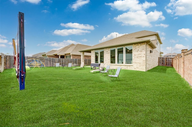 back of house with a yard and a patio