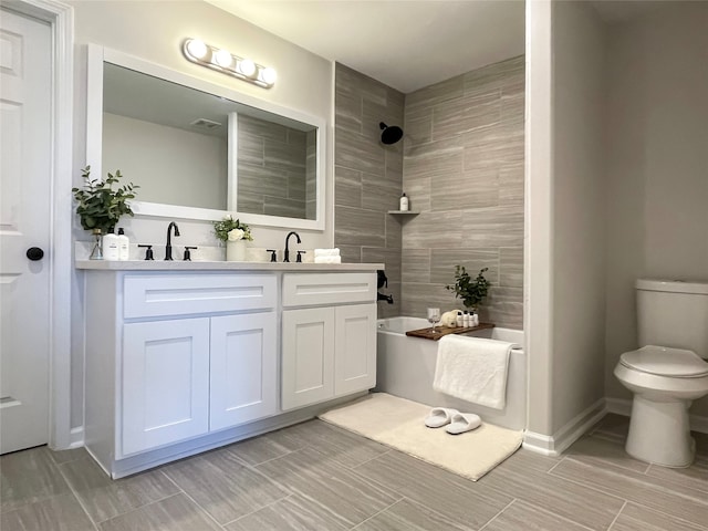 full bathroom featuring vanity, toilet, and tiled shower / bath combo