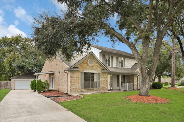 view of front of property featuring a front lawn, covered porch, and a garage