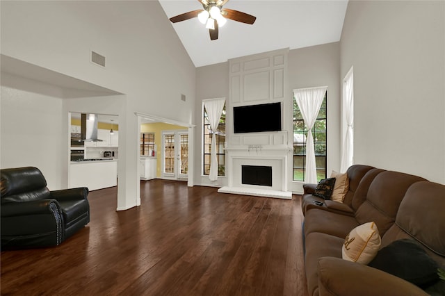 living room featuring ceiling fan, high vaulted ceiling, and dark hardwood / wood-style floors