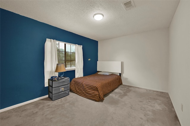 carpeted bedroom featuring a textured ceiling