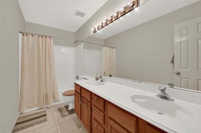 full bathroom with shower / bath combo, tile patterned flooring, a textured ceiling, toilet, and vanity