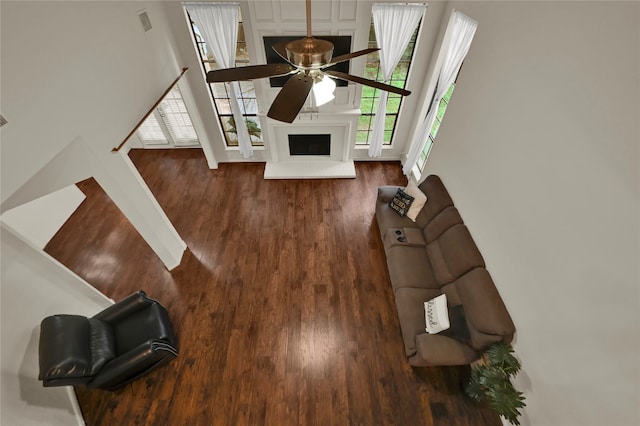 living room with ceiling fan and dark wood-type flooring