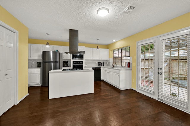 kitchen featuring a center island, dark wood-type flooring, white cabinets, hanging light fixtures, and island exhaust hood