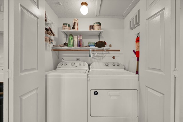 washroom featuring separate washer and dryer and a textured ceiling