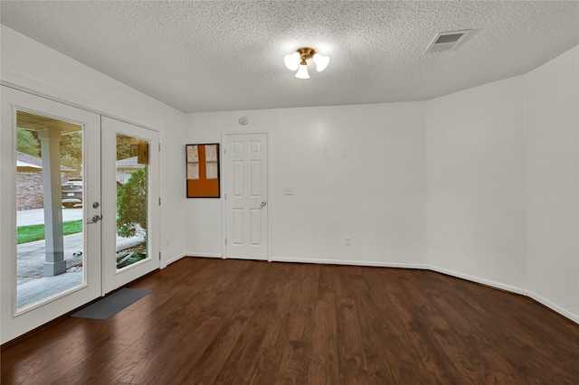 unfurnished room with french doors, dark hardwood / wood-style flooring, and a textured ceiling