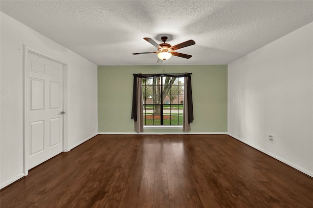 spare room featuring ceiling fan, dark wood-type flooring, and a textured ceiling