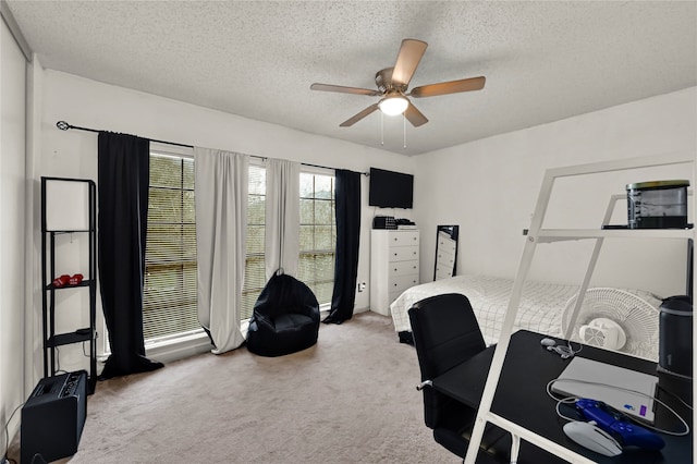 office space with a textured ceiling, carpet floors, and ceiling fan