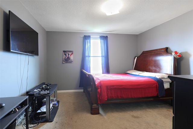 bedroom featuring carpet flooring and a textured ceiling