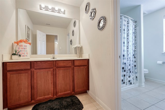 bathroom featuring curtained shower, tile patterned flooring, vanity, and toilet