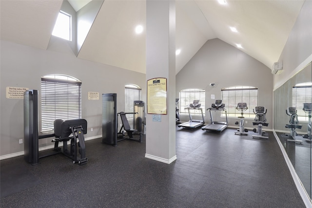 exercise room with plenty of natural light and high vaulted ceiling