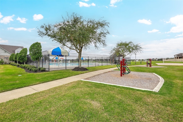 view of jungle gym with a fenced in pool and a yard