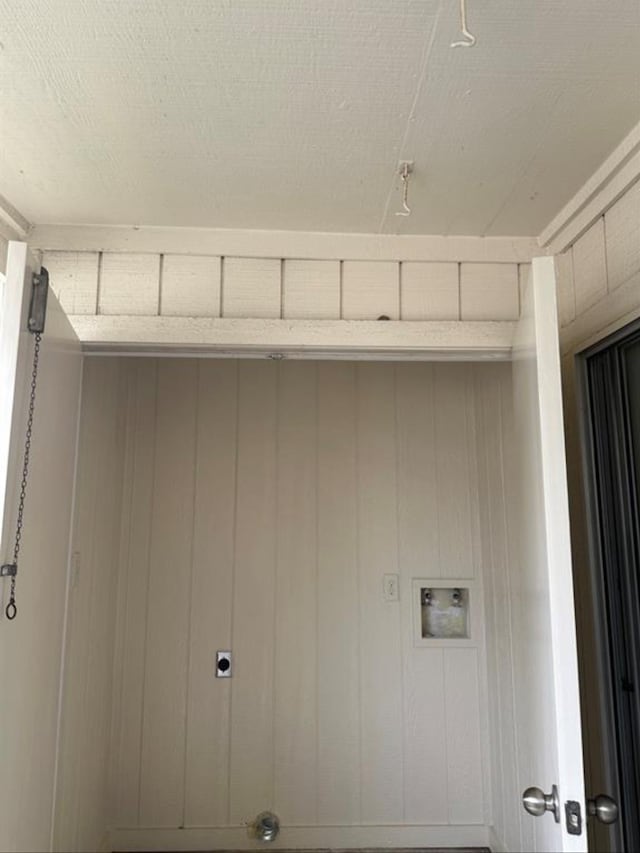 laundry area featuring wooden walls, electric dryer hookup, and hookup for a washing machine