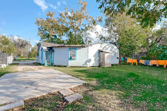 rear view of property featuring a yard