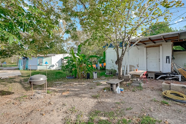 view of yard with an outdoor fire pit