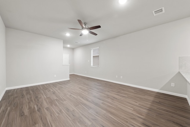 spare room featuring wood-type flooring and ceiling fan