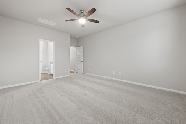 carpeted spare room featuring ceiling fan