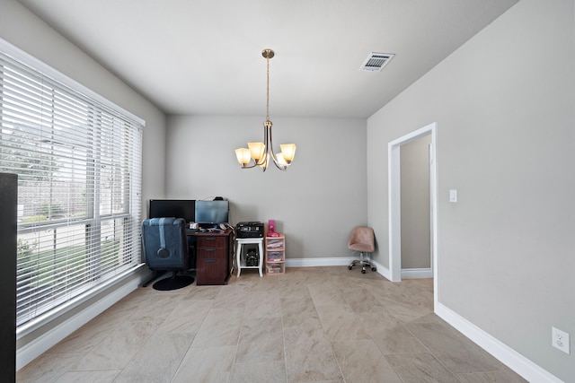 home office with a healthy amount of sunlight and an inviting chandelier