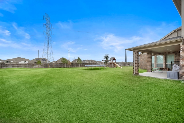 view of yard with a patio area and a trampoline