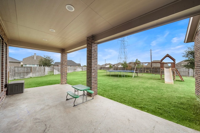 view of patio / terrace with a trampoline and a playground