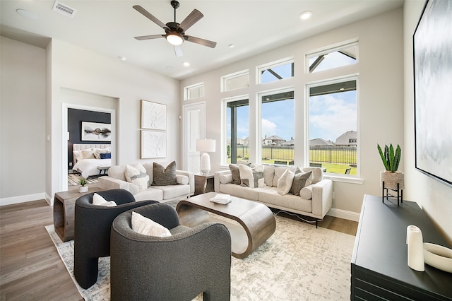 living room featuring light wood-type flooring and ceiling fan