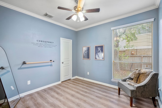 living area with ceiling fan, light hardwood / wood-style flooring, and ornamental molding