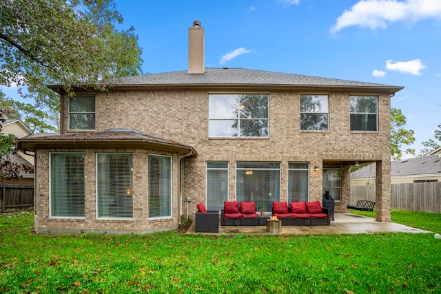 back of house with outdoor lounge area, a yard, and a patio