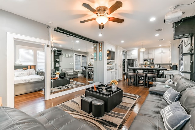 living room featuring hardwood / wood-style flooring and ceiling fan