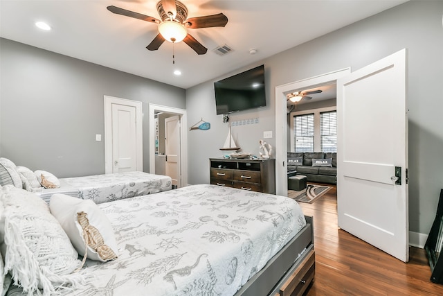 bedroom with dark hardwood / wood-style floors and ceiling fan