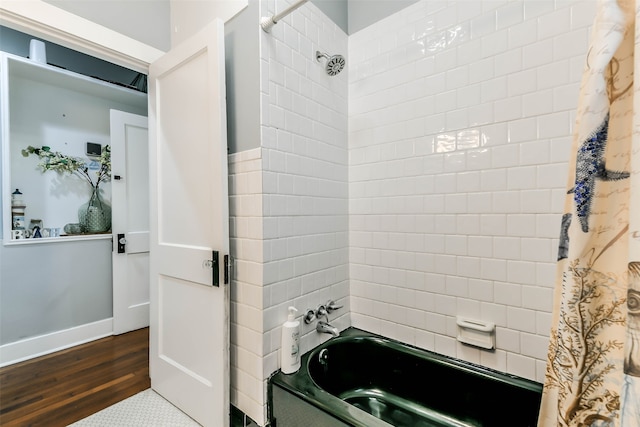 bathroom featuring hardwood / wood-style floors and shower / bath combination with curtain