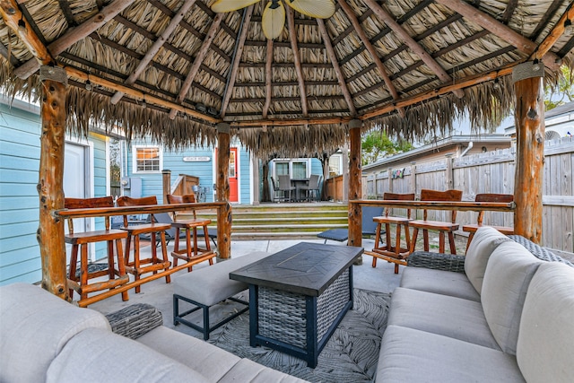 wooden deck with a gazebo, a patio area, and outdoor lounge area