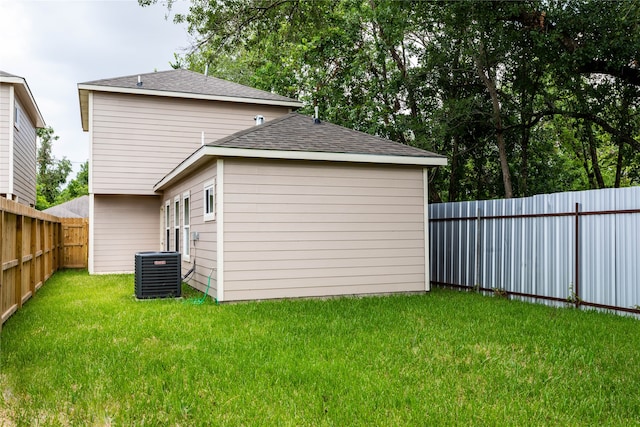 back of house with a yard and cooling unit