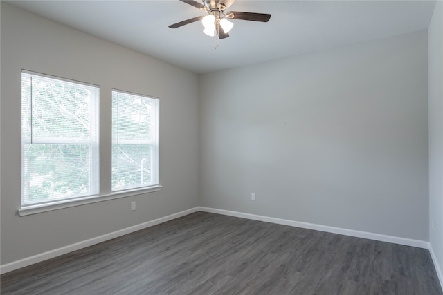 spare room with dark hardwood / wood-style floors, plenty of natural light, and ceiling fan