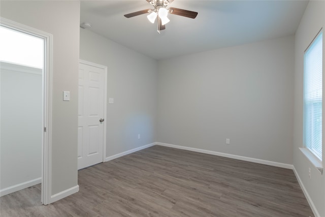 unfurnished room featuring ceiling fan and hardwood / wood-style floors