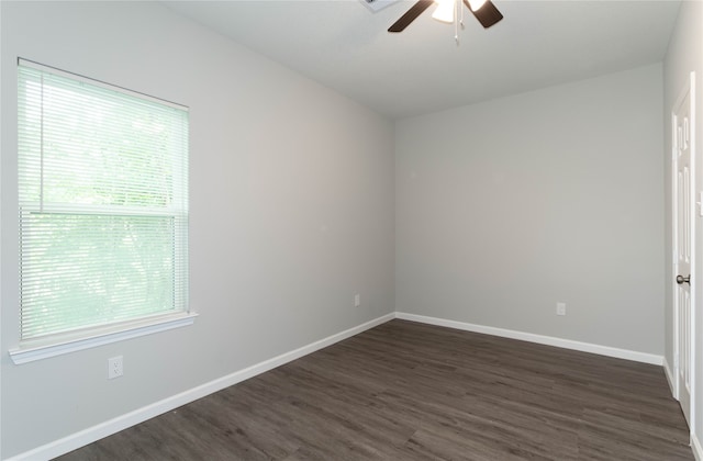 unfurnished room with ceiling fan and dark hardwood / wood-style flooring