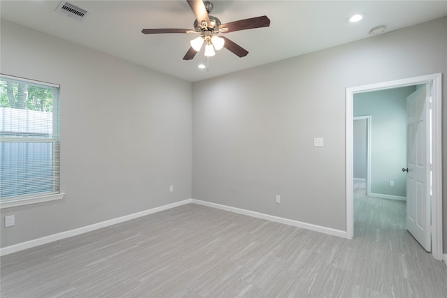 empty room featuring light hardwood / wood-style flooring and ceiling fan