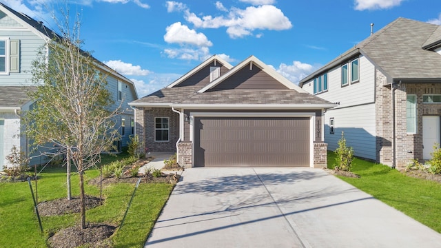 craftsman house with a front yard and a garage