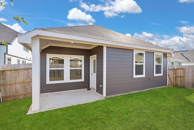 back of house with a lawn and a patio area