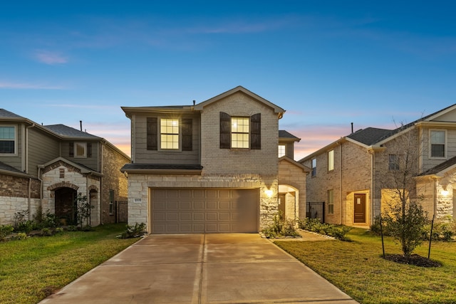 view of front of home with a lawn and a garage