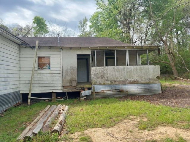 back of house featuring a sunroom