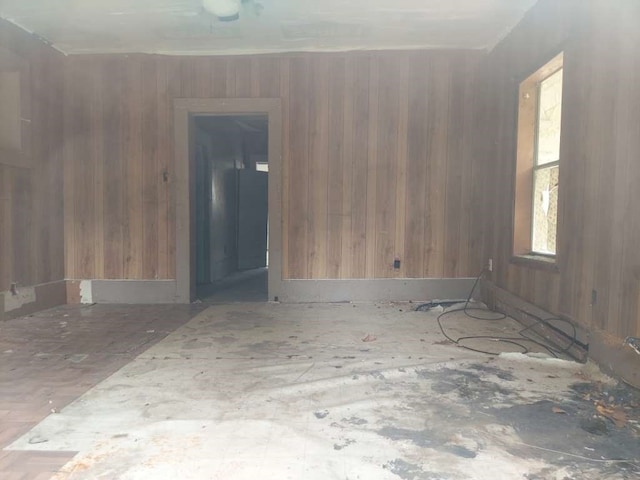 empty room featuring wood walls