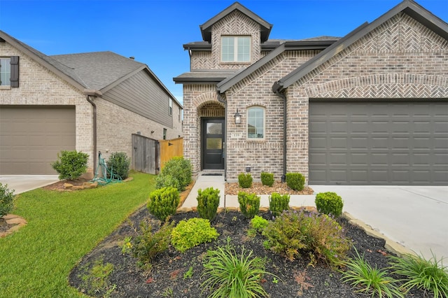 view of front of home featuring a garage and a front yard