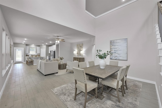 dining area with light wood-type flooring and ceiling fan