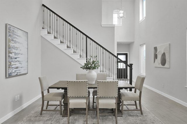 dining space with a high ceiling and an inviting chandelier